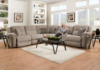 Living room with a sectional sofa, coffee table, and decor items.