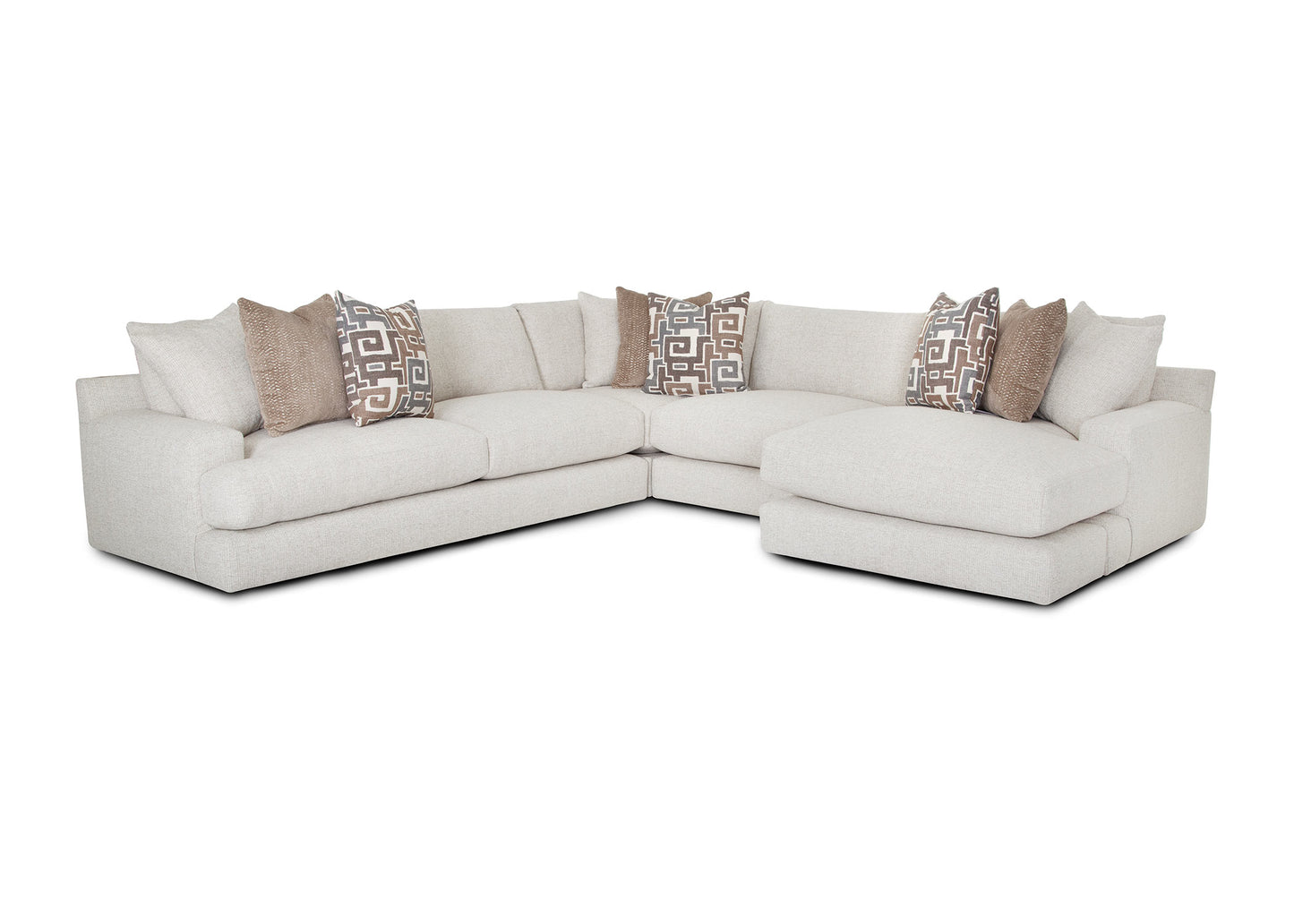 Sectional sofa with patterned pillows on a white background
