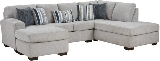 Gray sectional sofa with patterned cushions on a white background