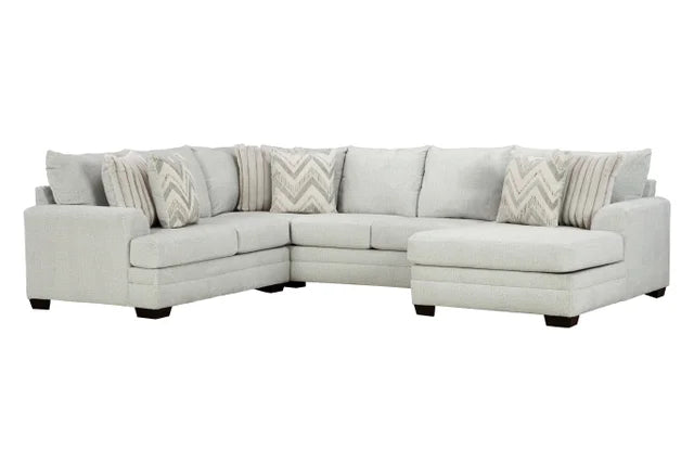 Gray sectional sofa with patterned cushions on a white background