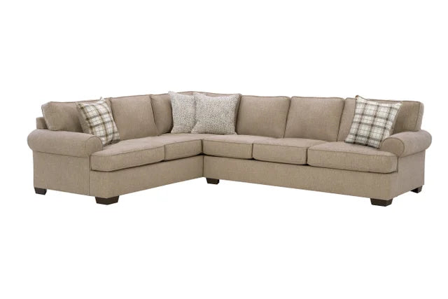 Beige sectional sofa with plaid and patterned throw pillows on a white background