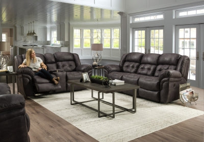Living room with dark brown leather recliner sofas and a coffee table.