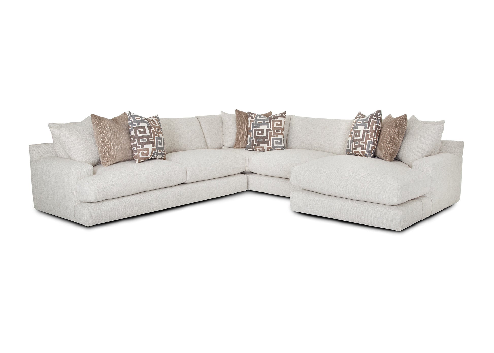 Sectional sofa with patterned pillows on a white background