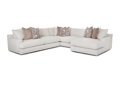 Sectional sofa with patterned pillows on a white background