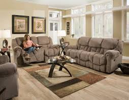 Living room with gray reclining sofa, coffee table, and decorative elements.