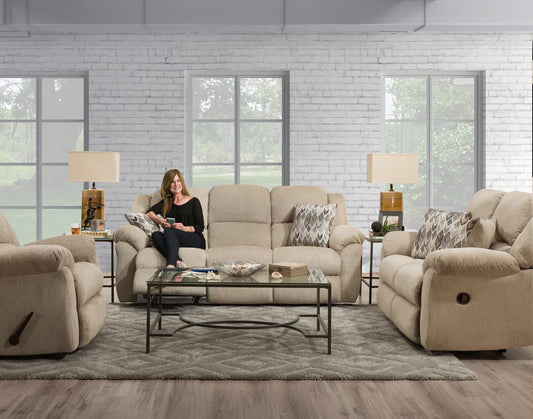 Woman sitting on a beige recliner in a living room with matching furniture.