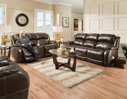Living room with brown leather sofas and a coffee table.