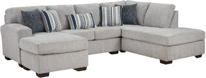 Gray sectional sofa with patterned cushions on a white background