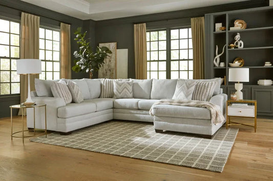 Living room with a sectional sofa, rug, and decorative items.