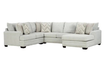 Gray sectional sofa with patterned cushions on a white background