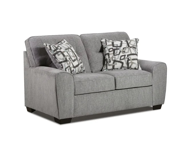 Gray sofa with patterned cushions on a white background