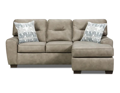 Beige sectional sofa with patterned pillows on a white background