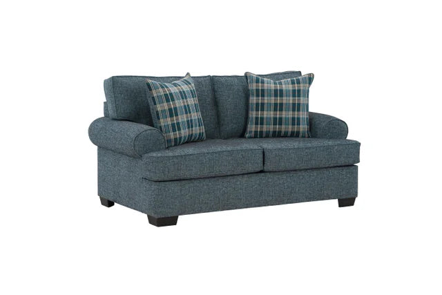 Blue sofa with plaid cushions on a white background