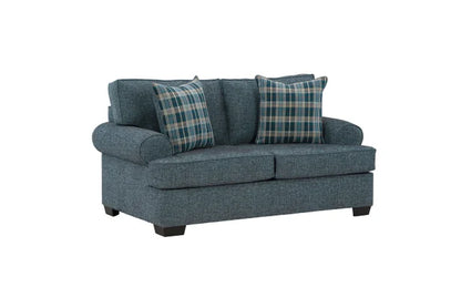 Blue sofa with plaid cushions on a white background