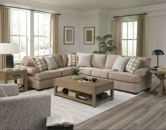 Living room with beige sectional sofa, wooden coffee table, and decorative elements.
