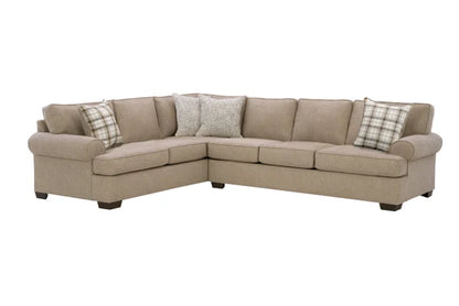 Beige sectional sofa with plaid and patterned throw pillows on a white background