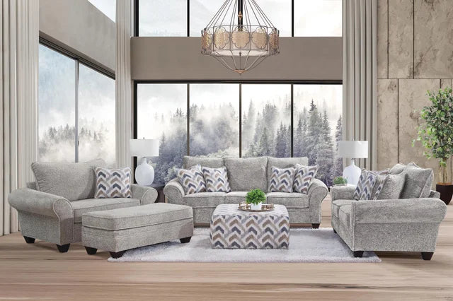 Gray sofa set in a modern living room with large windows.