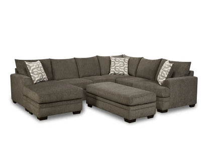 Gray sectional sofa with patterned cushions on a white background