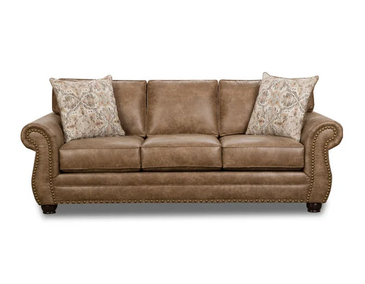 Brown leather sofa with patterned pillows on a white background