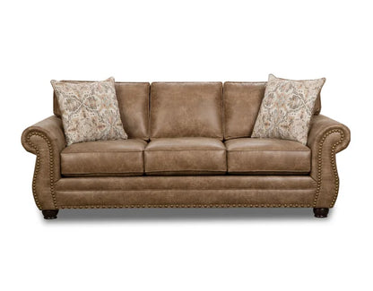 Brown leather sofa with patterned pillows on a white background