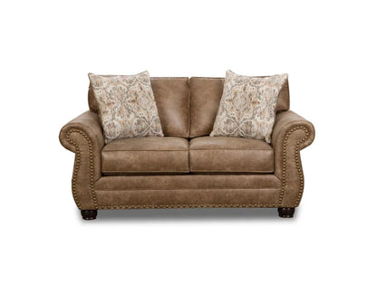 Brown leather sofa with patterned pillows on a white background