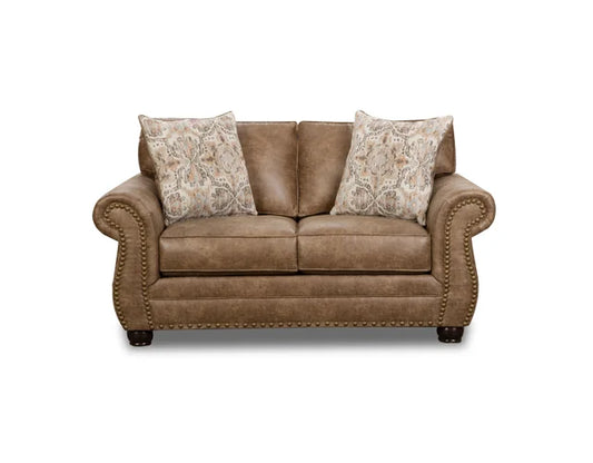 Brown leather sofa with patterned pillows on a white background