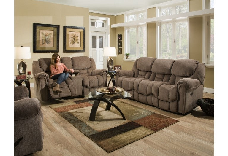 room with a brown sofa, loveseat with, and a brown rocker recliner. 
