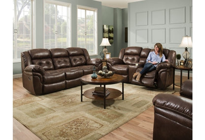 a room with a brown sofa, a brown loveseat, and a brown rocker recliner.
