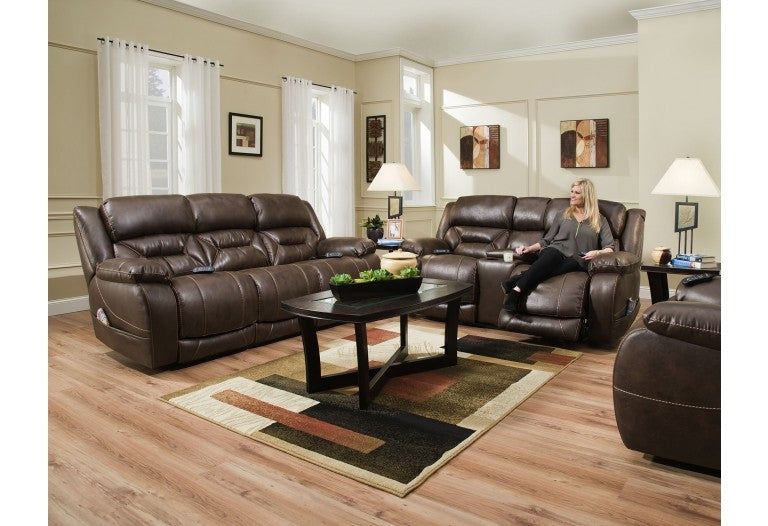 a reclining sofa, loveseat, and chair in a room each has a remote control attached to the arm. 